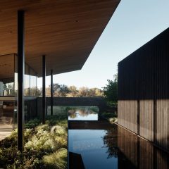 Building with broad roof and reflecting pool