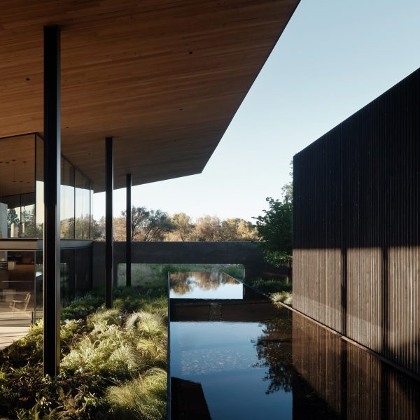 Building with broad roof and reflecting pool
