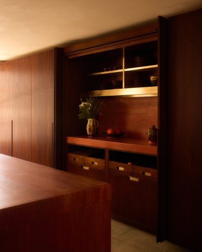 Red travertine kitchen by Anam Design Studio