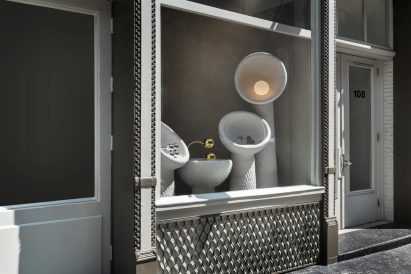 A window installation featuring hand-sculpted vessels faces SoHo's Wooster Street