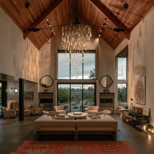 Lasvit's Herbarium chandelier suspended in a double-height living room