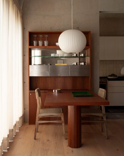 A dining table extending from a shelving unit