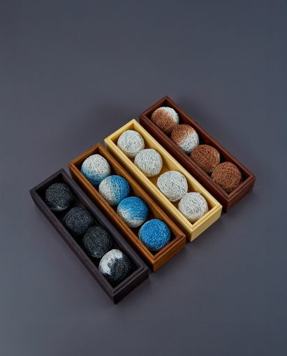 Four narrow boxes containing Hanji-covered balls