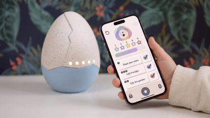 Hand holding an app in front of an egg