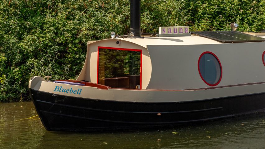 Soak canal boat moored beside trees