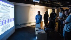 Photo of people looking at a projected screen