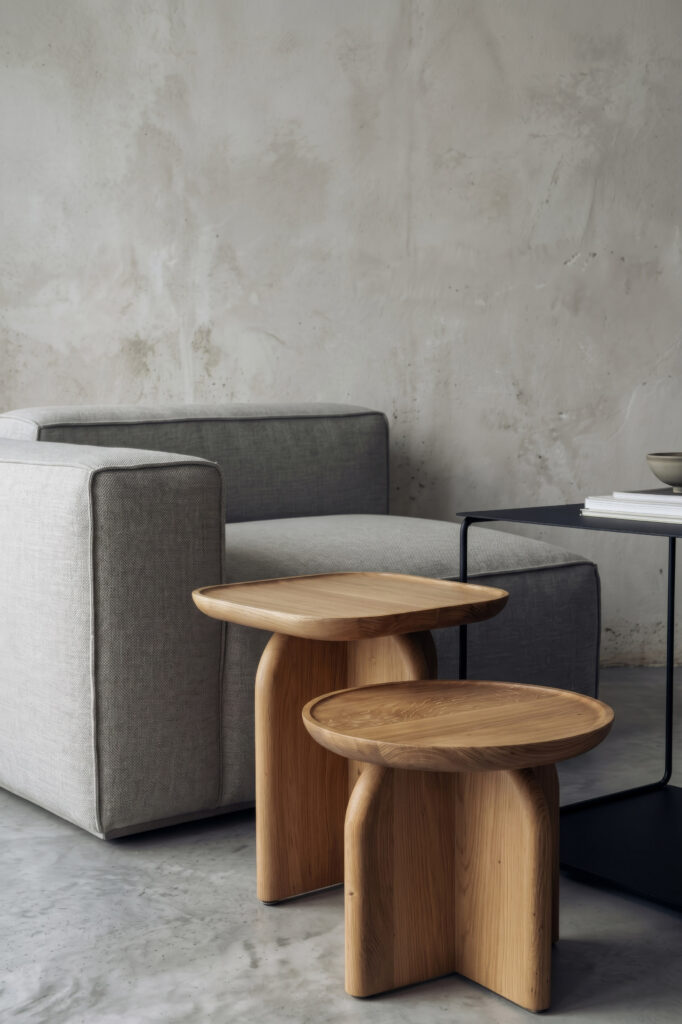 Two side tables next to a grey sofa