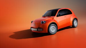 Orange-red Citroën 2CV concept car with rounded headlights and silver wheels