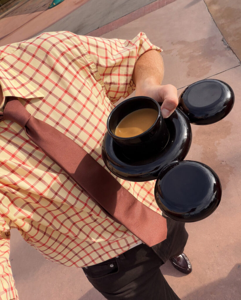 Man holding Mickey Mouse cup