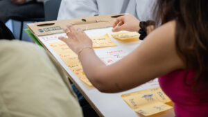 Person sticking sticky notes to board