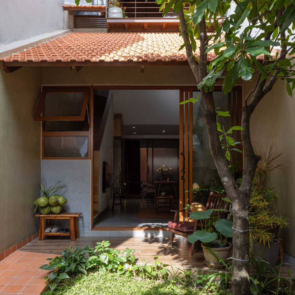 Terracotta tiles shelter skinny Roof House in Vietnam by Trung Nguyen Architects