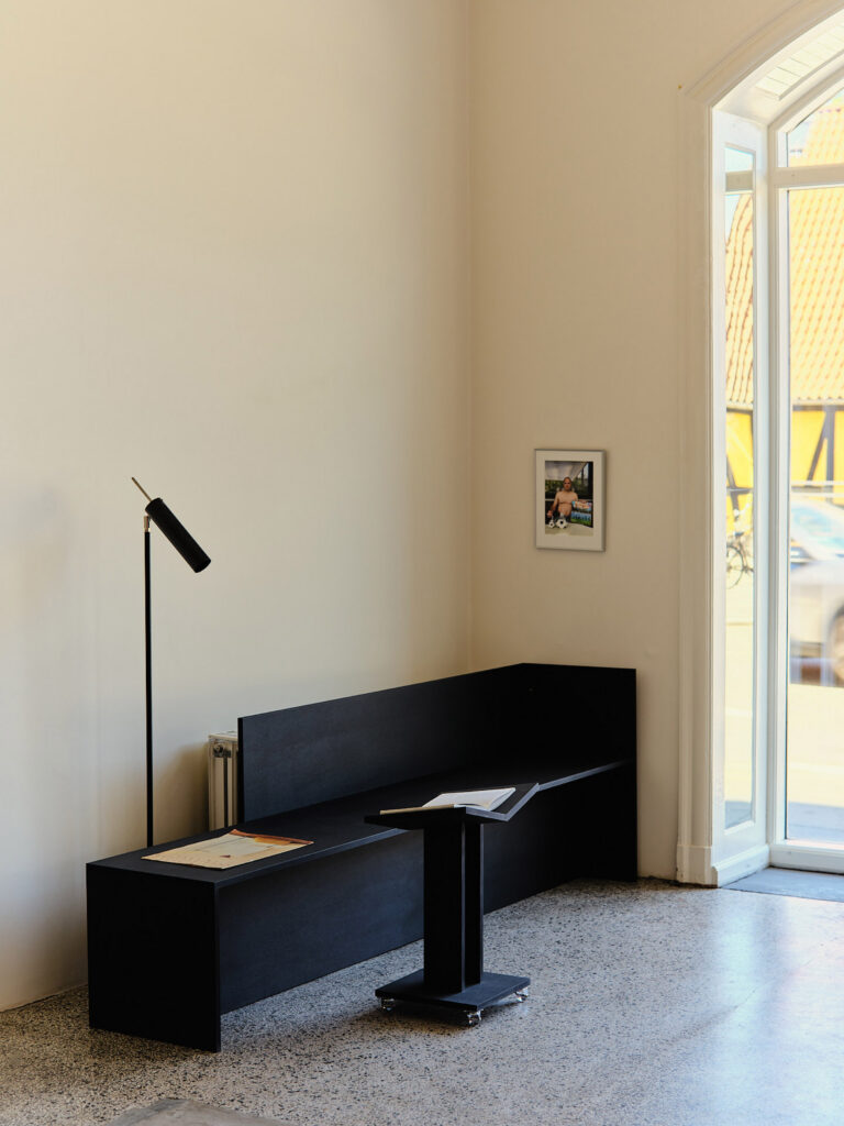 Black MDF bench and book trolley by Daniel Schofield in Simone Book Services