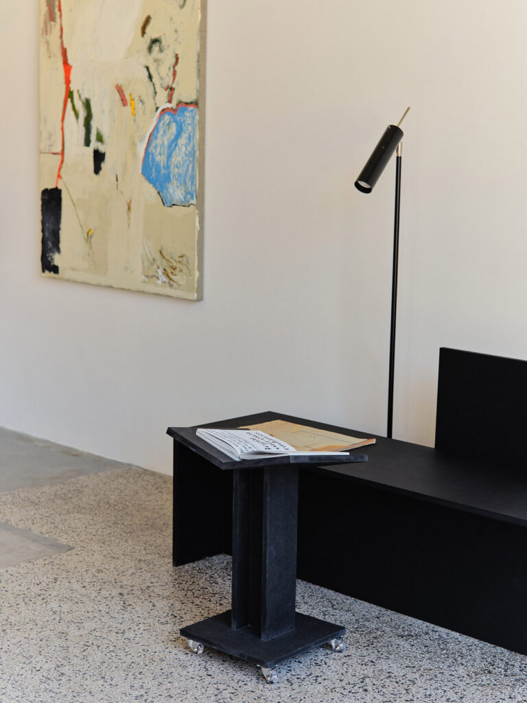 Black MDF bench and book trolley by Daniel Schofield in Simone Book Services