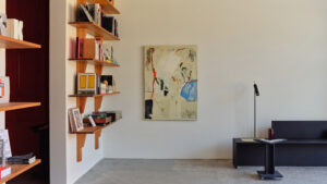 Cherry wood shelves by Derya Arpaç and black MDF furniture by Daniel Schofield in Simone Book Services