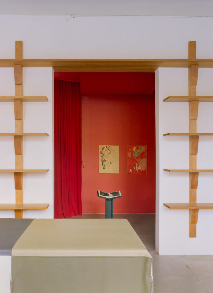 Cherry wood shelves by Derya Arpaç and leather counter by Lærke Ryom in Simone Book Services
