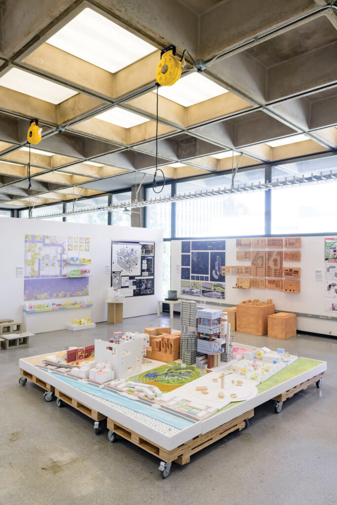 Model of city on palettes in exhibition space